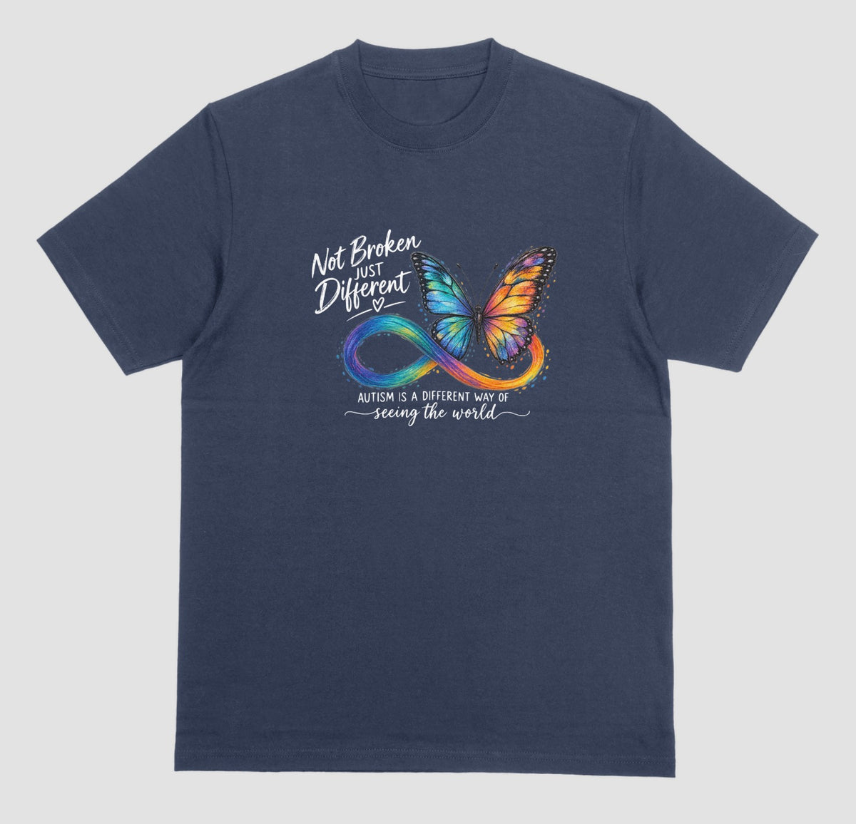 A navy blue t-shirt with a colorful butterfly and rainbow infinity symbol, with the text ‘Not Broken, Just Different’ and ‘Autism is a different way of seeing the world.’