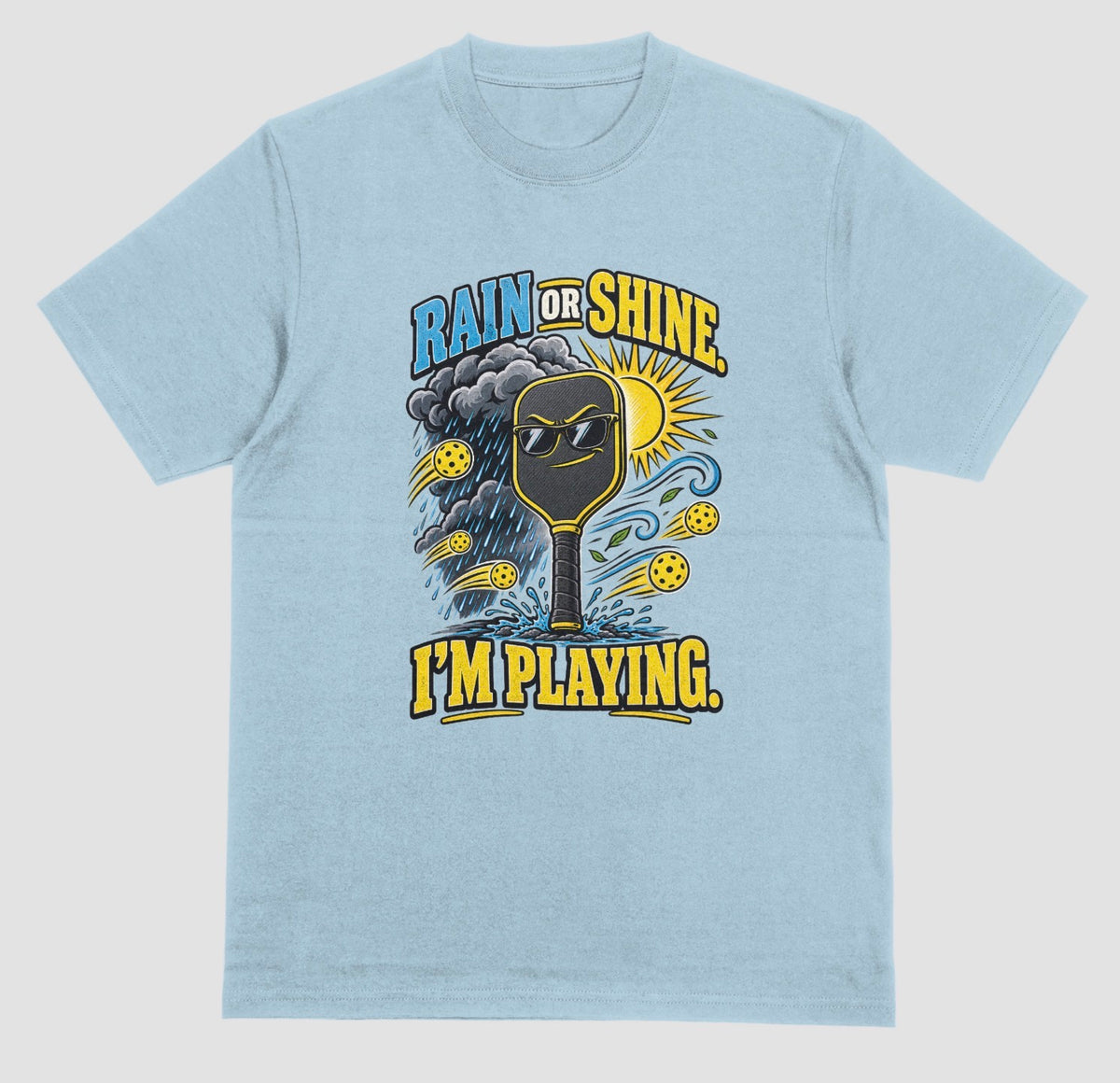 A light blue Funny pickleball shirt with a sunglasses paddle, storm cloud and sun that says Rain or Shine, I’m Playing