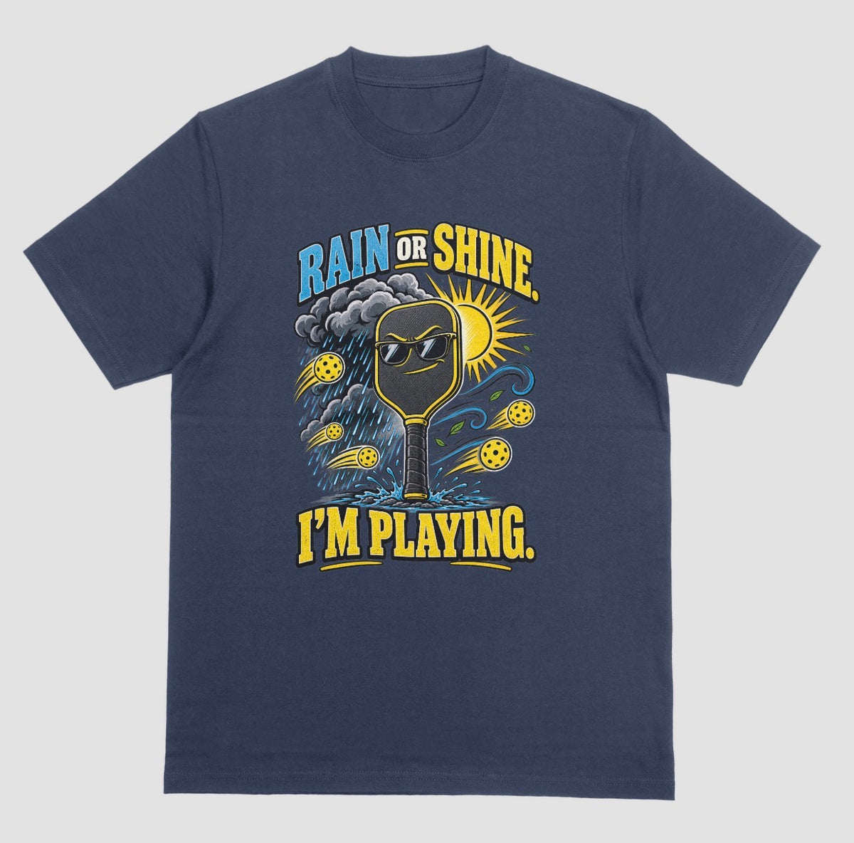 A navy blue Funny pickleball shirt with a sunglasses paddle, storm cloud and sun that says Rain or Shine, I’m Playing