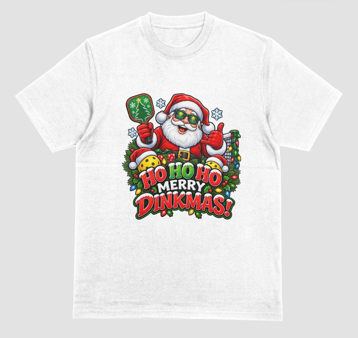 A white “Ho Ho Ho Merry Dinkmas” Christmas pickleball t-shirt with Santa holding a paddle