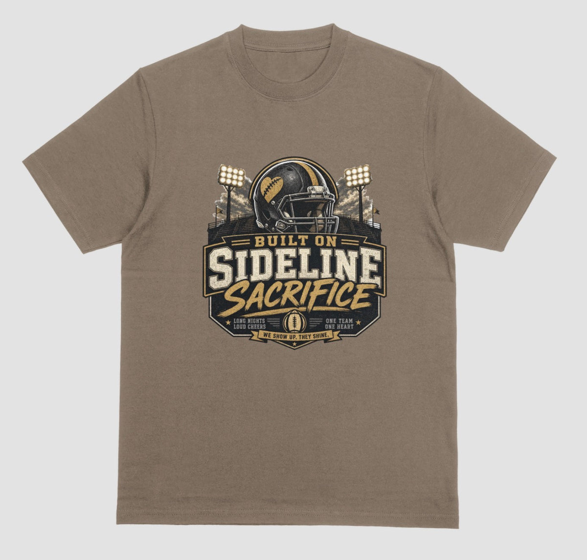 A brown savana crewneck t-shirt featuring a football-themed graphic on the chest with the text 'BUILT ON SIDELINE SACRIFICE' and a helmet illustration, shown against a light gray background.