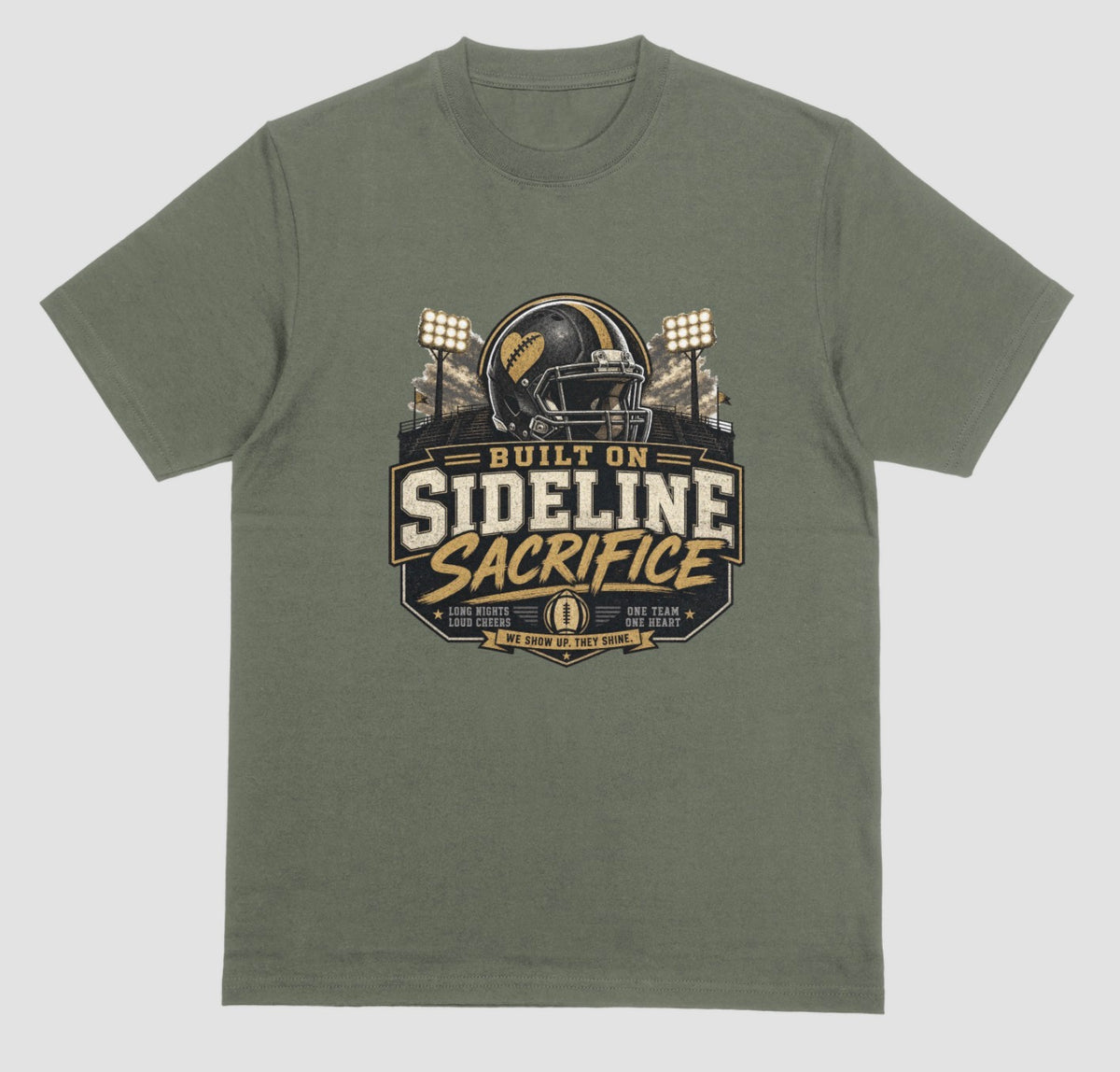 A military green crewneck t-shirt featuring a football-themed graphic on the chest with the text 'BUILT ON SIDELINE SACRIFICE' and a helmet illustration, shown against a light gray background.