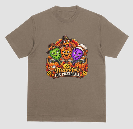 Brown savana t-shirt with “Thankful for Pickleball” design of three pilgrim-hat paddles, a turkey, pumpkins, and pie