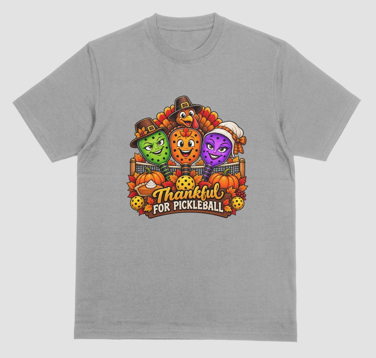 A grey t-shirt with “Thankful for Pickleball” design of three pilgrim-hat paddles, a turkey, pumpkins, and pie