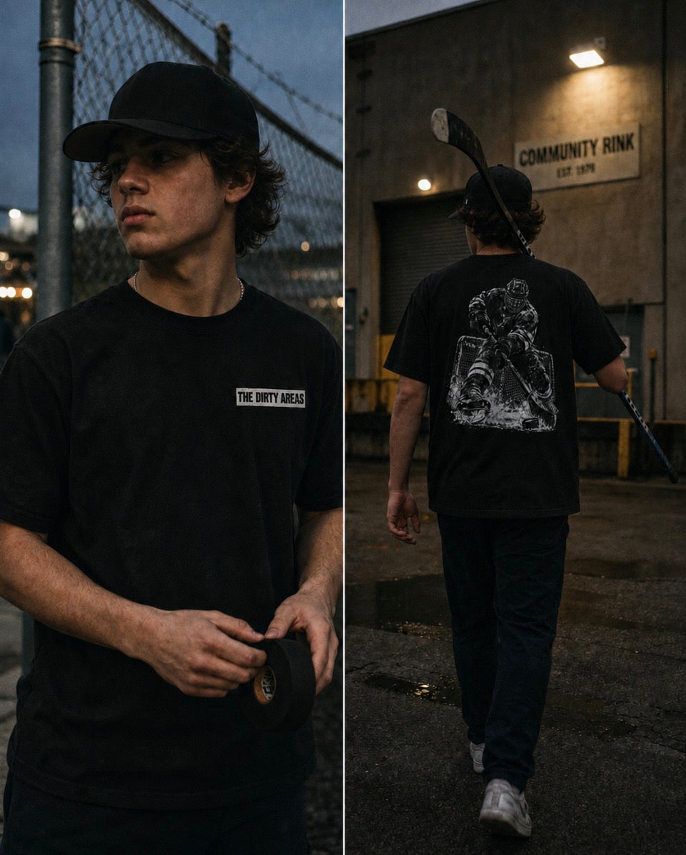 Split image of a young man in a black cap and black 'The Dirty Areas' t-shirt outside a community rink at dusk: on the left, a front view holding a roll of hockey tape; on the right, a back view carrying a hockey stick over his shoulder.