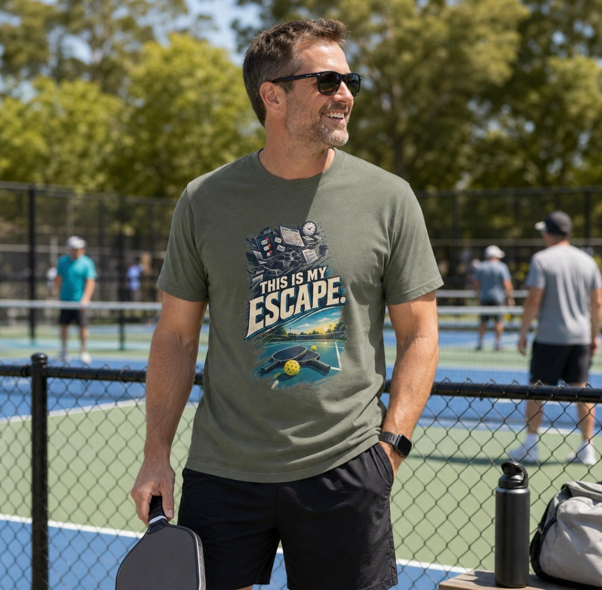 A man wearing military green shirt with a desk and Pickleball Paddle design that says This Is My Escape