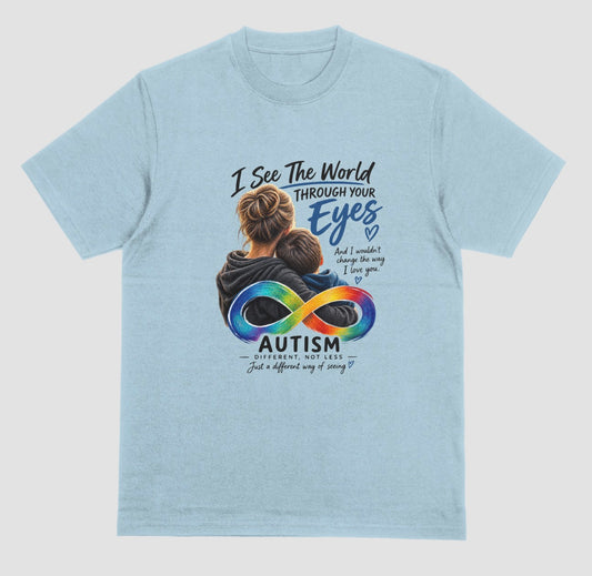 “Light blue t-shirt with a graphic of a parent hugging a child, a rainbow infinity symbol, and the text ‘I See the World Through Your Eyes’ and ‘Autism: Different, Not Less.’”