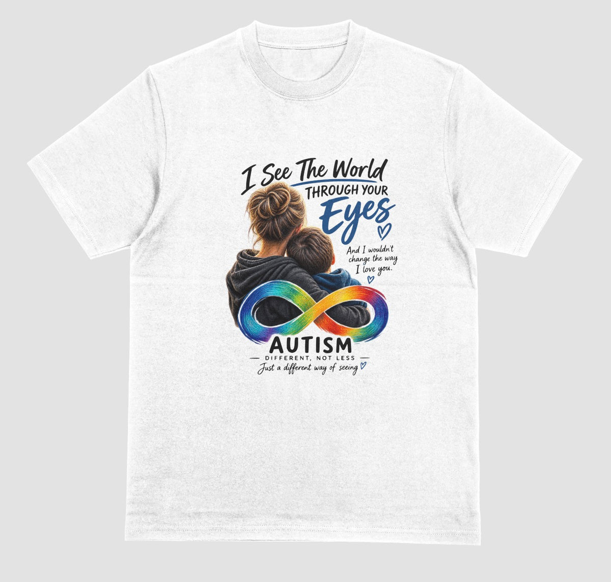A white t-shirt with a graphic of a parent hugging a child, a rainbow infinity symbol, and the text ‘I See the World Through Your Eyes’ and ‘Autism: Different, Not Less.’