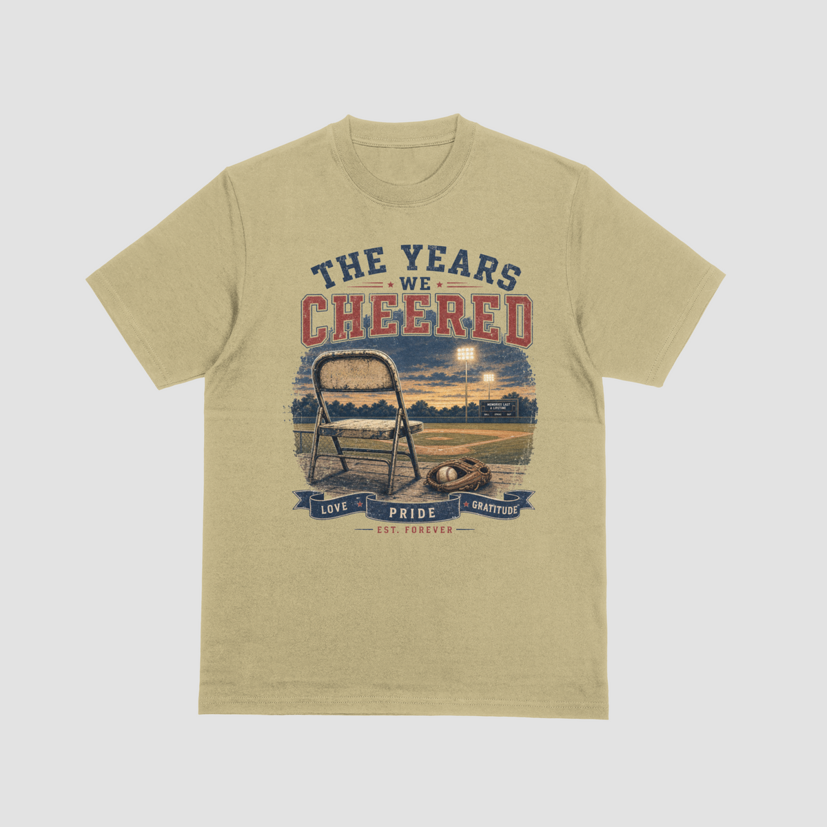 Sand — "The Years We Cheered baseball t-shirt in sand featuring a folding chair, baseball glove, and field graphic with Love, Pride, Gratitude banner"