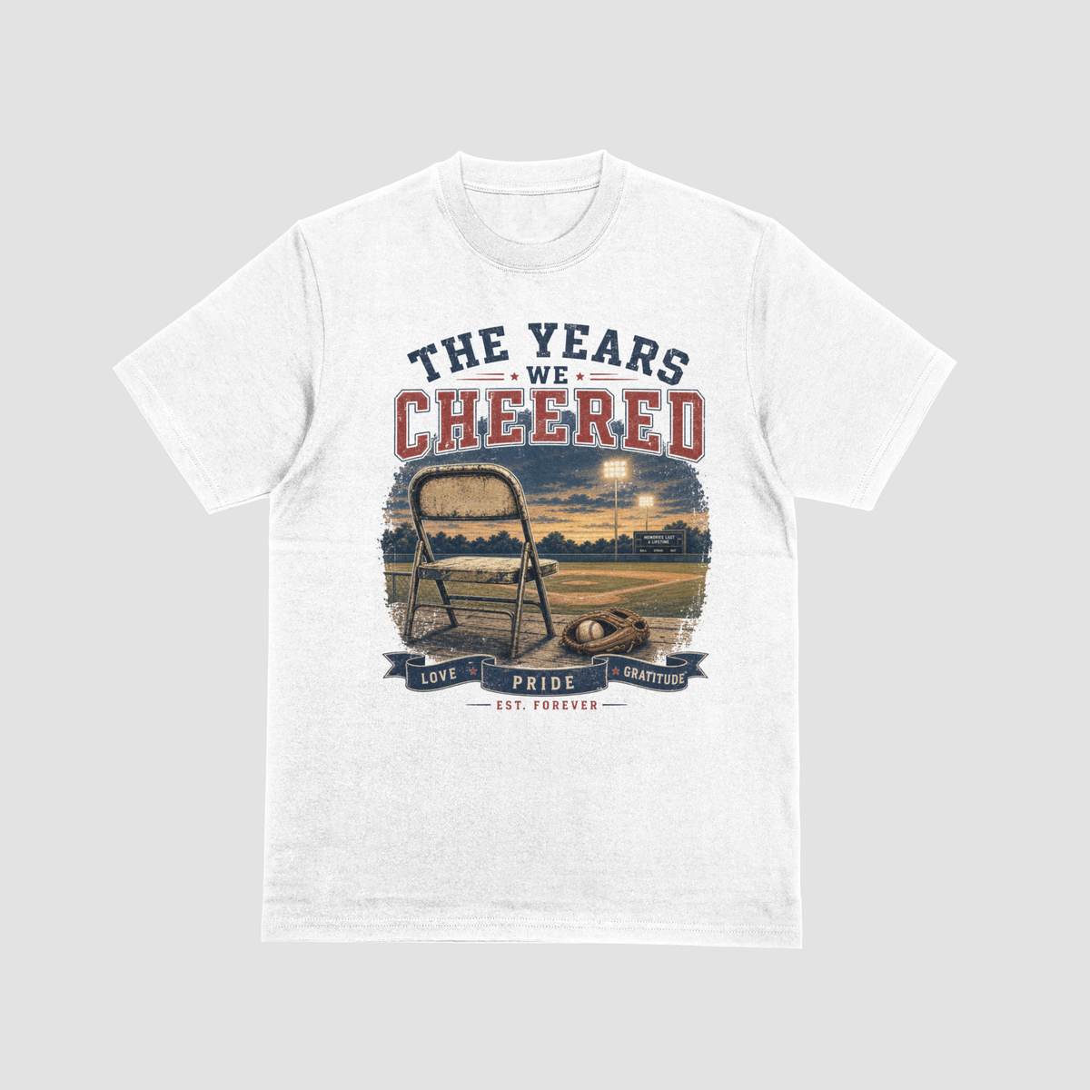 White — "The Years We Cheered baseball t-shirt in white featuring a folding chair, baseball glove, and field graphic with Love, Pride, Gratitude banner"