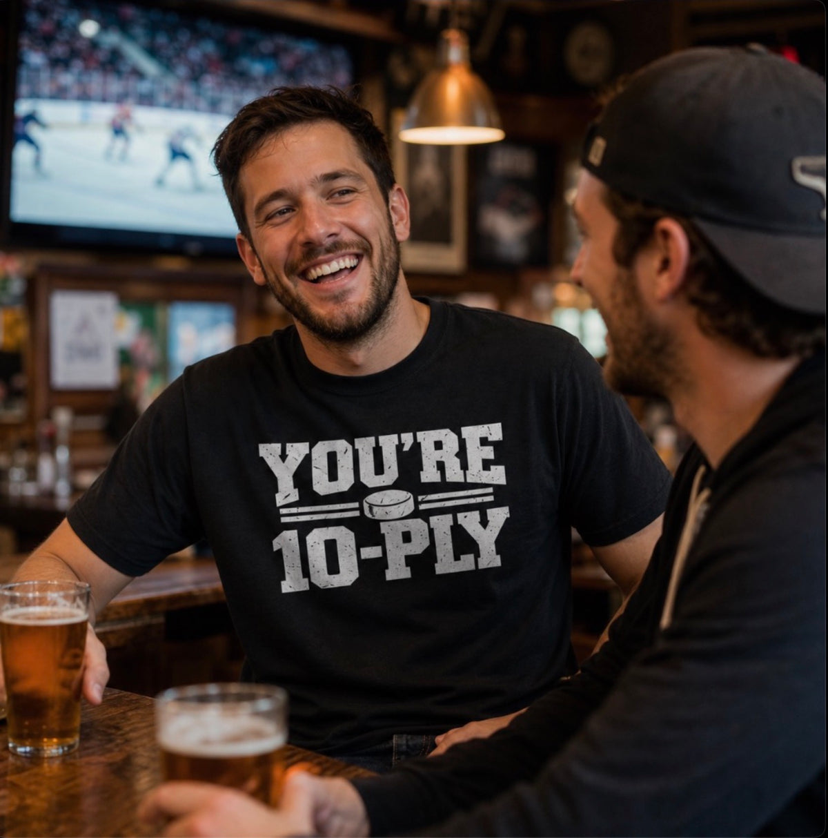 A man at the bar wearing a black You're 10-Ply crewneck t-shirt